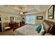 Spacious main bedroom boasts tray ceiling, ceiling fan, and is furnished with a wooden dresser at 1300 Ruddy Ct., Conway, SC 29527