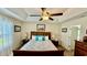 Comfortable main bedroom features tray ceiling, ceiling fan, and plenty of natural light from the large window at 1300 Ruddy Ct., Conway, SC 29527