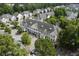 Aerial view of multi-story condos featuring balconies, ample parking, and tree-lined streets at 134 Scotch Broom Dr. # K - 201, Little River, SC 29566