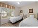 Bright bedroom featuring two twin beds, a ceiling fan, and a window with natural light at 134 Scotch Broom Dr. # K - 201, Little River, SC 29566