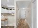 Well-lit hallway with light wood flooring, a kitchen view, and access to other rooms at 134 Scotch Broom Dr. # K - 201, Little River, SC 29566