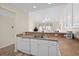 Bright kitchen featuring white cabinetry, essential appliances, and a breakfast bar area at 134 Scotch Broom Dr. # K - 201, Little River, SC 29566