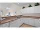 Bright kitchen with white cabinets, light counters, and an open view into the living area at 134 Scotch Broom Dr. # K - 201, Little River, SC 29566