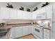Functional kitchen features white appliances, white cabinetry, and ample counter space at 134 Scotch Broom Dr. # K - 201, Little River, SC 29566