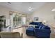 Inviting living room featuring a ceiling fan, blue sofas, and sliding glass doors to the balcony at 134 Scotch Broom Dr. # K - 201, Little River, SC 29566