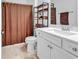 Neutral bathroom featuring a white vanity, a patterned shower curtain, and a wood storage shelf at 1360 Littleleaf Loop, North Myrtle Beach, SC 29582