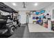 Spacious garage with a golf cart parked on the black epoxy floor with storage on the white walls at 1360 Littleleaf Loop, North Myrtle Beach, SC 29582