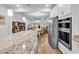 Open-concept kitchen with a granite countertop, stainless steel appliances, and a large island at 1360 Littleleaf Loop, North Myrtle Beach, SC 29582