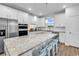 Spacious kitchen island featuring granite countertops and four stylish bar stools for casual dining at 1360 Littleleaf Loop, North Myrtle Beach, SC 29582