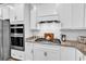 Close-up of the kitchen with stainless steel appliances, granite counters and white backsplash at 1360 Littleleaf Loop, North Myrtle Beach, SC 29582