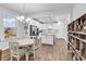 Bright kitchen with an island, stainless steel appliances, and hardwood floors, adjacent to dining area at 1360 Littleleaf Loop, North Myrtle Beach, SC 29582