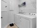 Functional laundry room equipped with a washing machine and dryer, plus convenient shelving at 1360 Littleleaf Loop, North Myrtle Beach, SC 29582