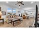 Inviting living room featuring an open floor plan, wood floors, and large windows at 1360 Littleleaf Loop, North Myrtle Beach, SC 29582