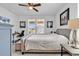 This bright bedroom has neutral colors, a large bed, and artwork adorning the white walls at 1360 Littleleaf Loop, North Myrtle Beach, SC 29582