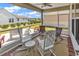 Cozy screened-in patio with rocking chairs and outdoor seating overlooks a landscaped backyard at 1360 Littleleaf Loop, North Myrtle Beach, SC 29582