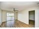 Bright bedroom with wood flooring, ceiling fan, and sliding doors to a balcony with a pond view at 1425 Teague Rd. # 203, Myrtle Beach, SC 29577