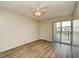 Bedroom featuring laminate floors, ceiling fan, and sliding glass doors that provides lake view access at 1425 Teague Rd. # 203, Myrtle Beach, SC 29577