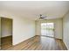 Bright bedroom with wood flooring, ceiling fan, and sliding doors to a balcony with a view at 1425 Teague Rd. # 203, Myrtle Beach, SC 29577