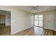 Bedroom features wood floors, neutral walls, and a sliding door to a lake view balcony at 1425 Teague Rd. # 203, Myrtle Beach, SC 29577
