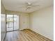 Bedroom featuring wood floors, a ceiling fan, and a sliding door leading to a lake view balcony at 1425 Teague Rd. # 203, Myrtle Beach, SC 29577