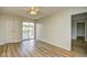 Bedroom featuring laminate wood floors, ceiling fan, and sliding door leading to balcony with lake view at 1425 Teague Rd. # 203, Myrtle Beach, SC 29577