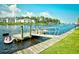 Waterfront view of a private boat dock with a boat lift on a calm river at 1425 Teague Rd. # 203, Myrtle Beach, SC 29577