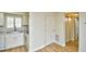 Open floor plan with a kitchen featuring wood look flooring, and white cabinetry at 1425 Teague Rd. # 203, Myrtle Beach, SC 29577