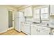 Bright kitchen with stainless sink, granite countertops, wood floor, white cabinets and appliances at 1425 Teague Rd. # 203, Myrtle Beach, SC 29577