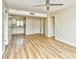 Open-concept living area with wood flooring leading to a kitchen and bedroom entrance at 1425 Teague Rd. # 203, Myrtle Beach, SC 29577