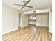 Spacious living area with wood flooring featuring a ceiling fan and bright kitchen view at 1425 Teague Rd. # 203, Myrtle Beach, SC 29577