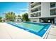 Inviting in-ground pool area with lounge chairs and lush landscaping near a multi-story condo building at 1425 Teague Rd. # 203, Myrtle Beach, SC 29577
