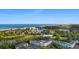 Aerial view of Summerhouse condos by the ocean, nestled near a lake and lush green spaces at 14290 Ocean Hwy. # 407, Pawleys Island, SC 29585