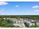 Expansive aerial view of condo complex with a large pool area, lake, and beautiful surrounding greenery at 14290 Ocean Hwy. # 407, Pawleys Island, SC 29585