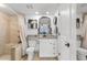 Well-lit bathroom features granite countertops, tiled shower, and decorative mirror at 14290 Ocean Hwy. # 407, Pawleys Island, SC 29585