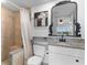 Elegant bathroom features a granite countertop, decorative mirror, and tiled shower at 14290 Ocean Hwy. # 407, Pawleys Island, SC 29585