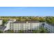 Elevated view of the condo building with private balconies and beautiful surrounding foliage at 14290 Ocean Hwy. # 407, Pawleys Island, SC 29585