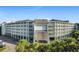 Exterior view of the multi-story condo building with a covered entrance and rows of private balconies at 14290 Ocean Hwy. # 407, Pawleys Island, SC 29585