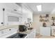 Well-lit kitchen with white cabinets, granite countertops, and stainless steel appliances at 14290 Ocean Hwy. # 407, Pawleys Island, SC 29585