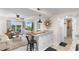 Updated kitchen with granite countertops, a breakfast bar, seating for three, and seamless flow into the living space at 14290 Ocean Hwy. # 407, Pawleys Island, SC 29585