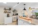 Bright kitchen with granite countertops, modern appliances, shelving, and convenient access to the adjacent living area at 14290 Ocean Hwy. # 407, Pawleys Island, SC 29585