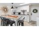 Galley kitchen with granite countertops, breakfast bar, white cabinets and appliances, and direct access to the front door at 14290 Ocean Hwy. # 407, Pawleys Island, SC 29585