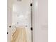 Modern bathroom with white cabinets, plank flooring, and a shower-tub combo at 1464 Hawthorn Dr., Pawleys Island, SC 29585