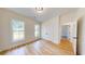 Light-filled bedroom with two windows, plank flooring, and a closet, creating a welcoming space at 1464 Hawthorn Dr., Pawleys Island, SC 29585