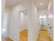 Hallway featuring an opening to a walk-in closet and powder room with a pedestal sink at 1464 Hawthorn Dr., Pawleys Island, SC 29585