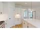 Bright, open kitchen with a center island, white cabinets, quartz countertops and stainless steel appliances at 1464 Hawthorn Dr., Pawleys Island, SC 29585