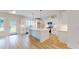 Modern kitchen with white cabinets, island with breakfast bar, stainless steel appliances, and wood-look flooring at 1464 Hawthorn Dr., Pawleys Island, SC 29585