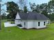Rear exterior features white siding, dark roof, concrete driveway, and two-car garage, with a grassy yard at 1464 Hawthorn Dr., Pawleys Island, SC 29585