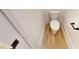 Bathroom with wood-look flooring and a classic white toilet at 1464 Hawthorn Dr., Pawleys Island, SC 29585