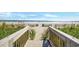 Wooden walkway leading to the beach with ocean views and dune vegetation at 1501 S Ocean Blvd. # 639, Myrtle Beach, SC 29577