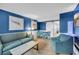Comfortable living room with blue walls, tile floors, and a dining area with beach themed art at 1501 S Ocean Blvd. # 639, Myrtle Beach, SC 29577
